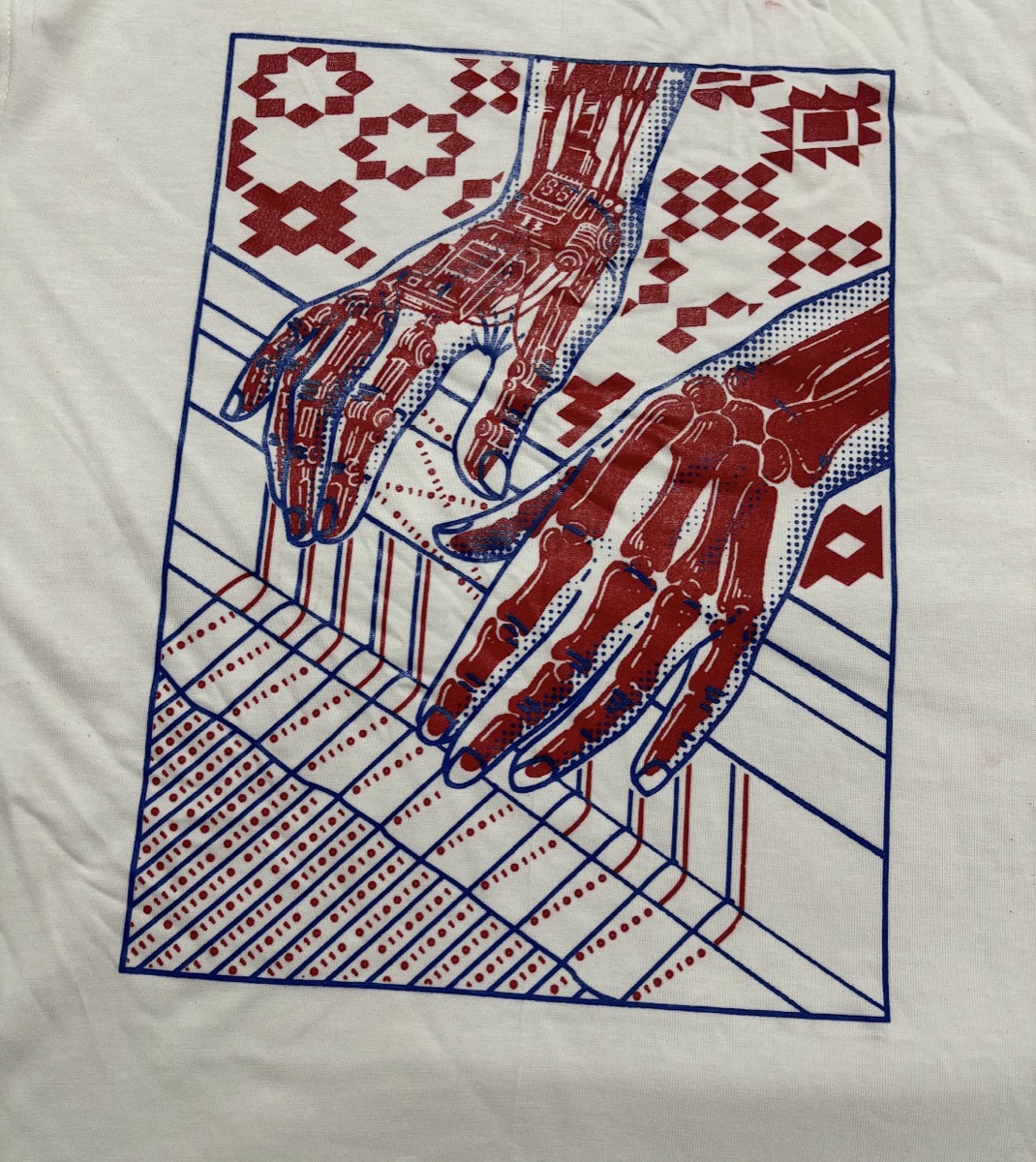 Sarvam Epoch t-shirt: a robotic hand and a human hand reaching toward each other over binary and pixel-tapestry patterns